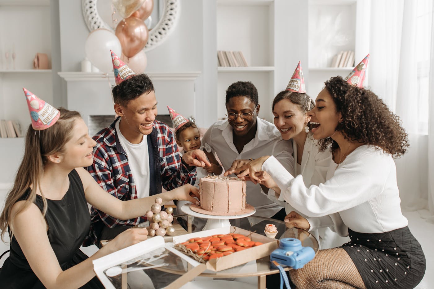 Friends gathered around a birthday cake during a celebration at home